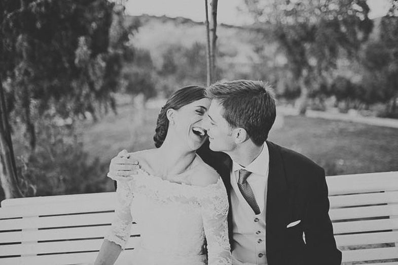 A romantic black and white moment shared on a park bench.