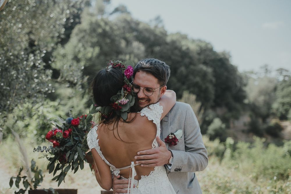 Romantic moment between newlyweds at an outdoor wedding celebration.