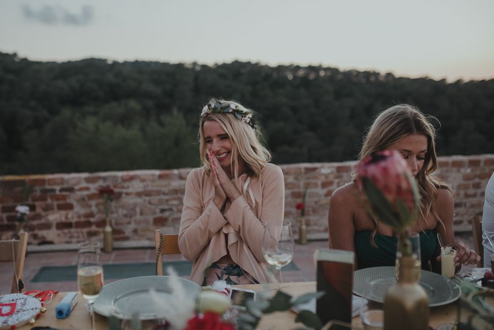 Emotional reactions during outdoor wedding reception with mountains in background.