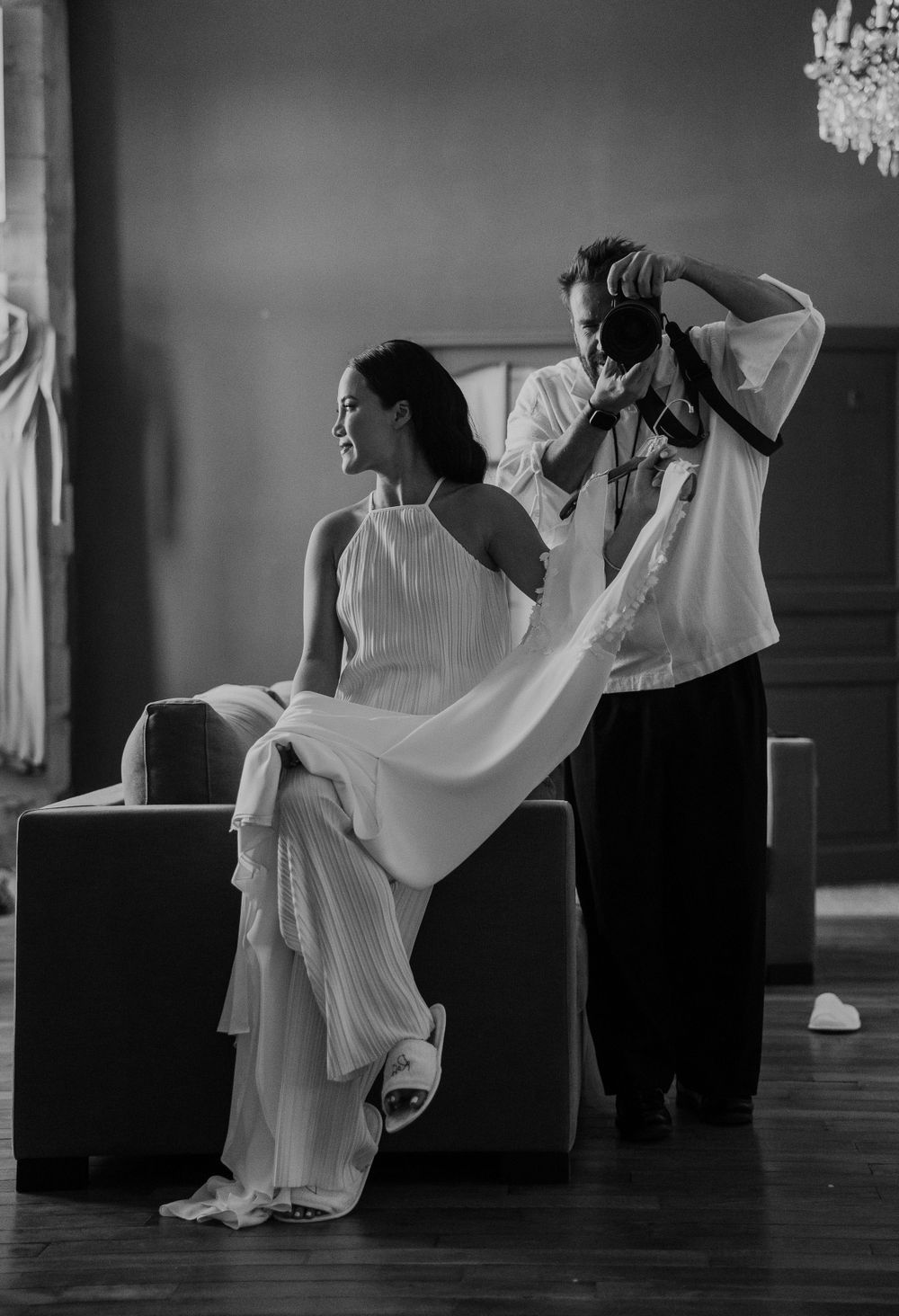 Black and white sequence of wedding dress preparation in an elegant room.