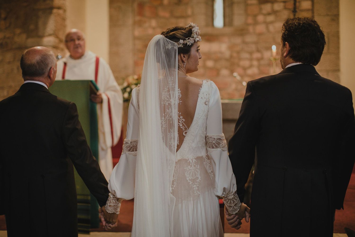 Traditional church wedding ceremony with bride in flowing dress and veil.