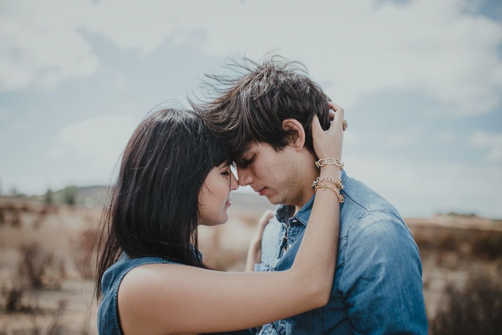 An intimate close-up moment between two people wearing blue and white.