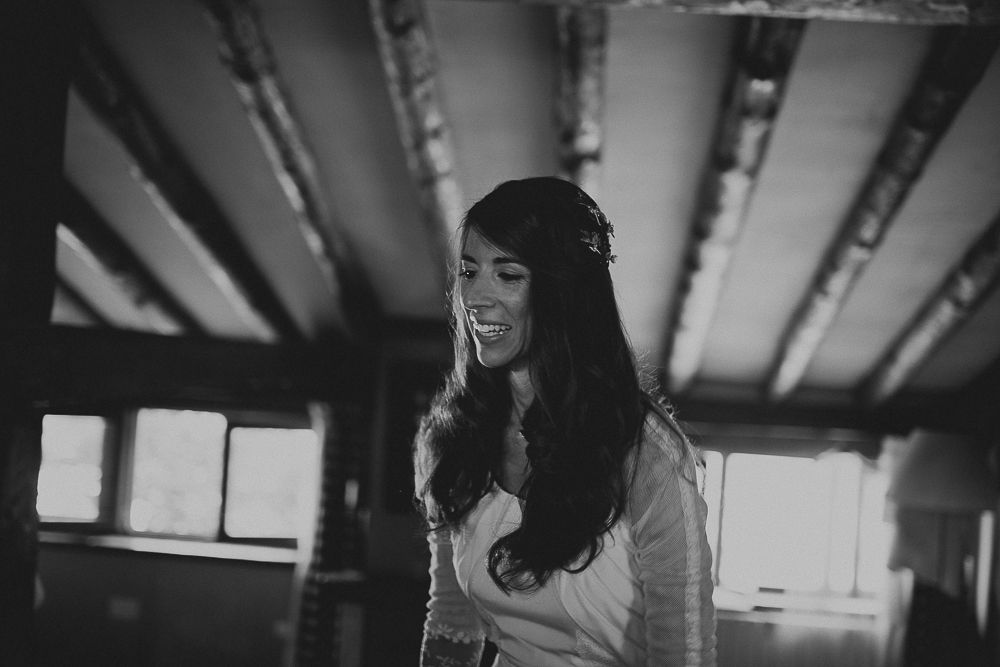 Black and white portrait showing joyful expression with natural window lighting.