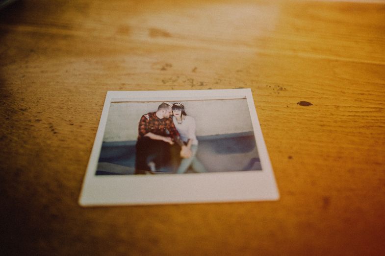 Vintage polaroid photograph lying on a wooden surface.