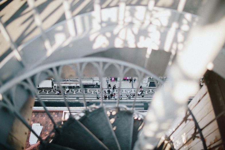 Abstract architectural view through spiral staircase with blurred city background.