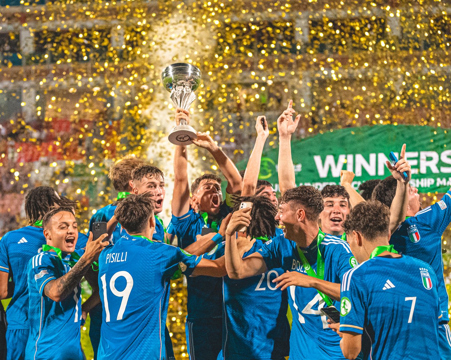 Soccer team celebrating victory with golden confetti falling in stadium lights.