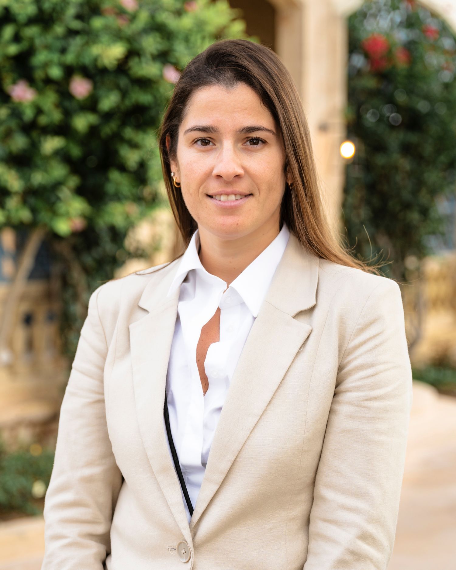Business professional photoshoot against a classic stone building with natural lighting.
