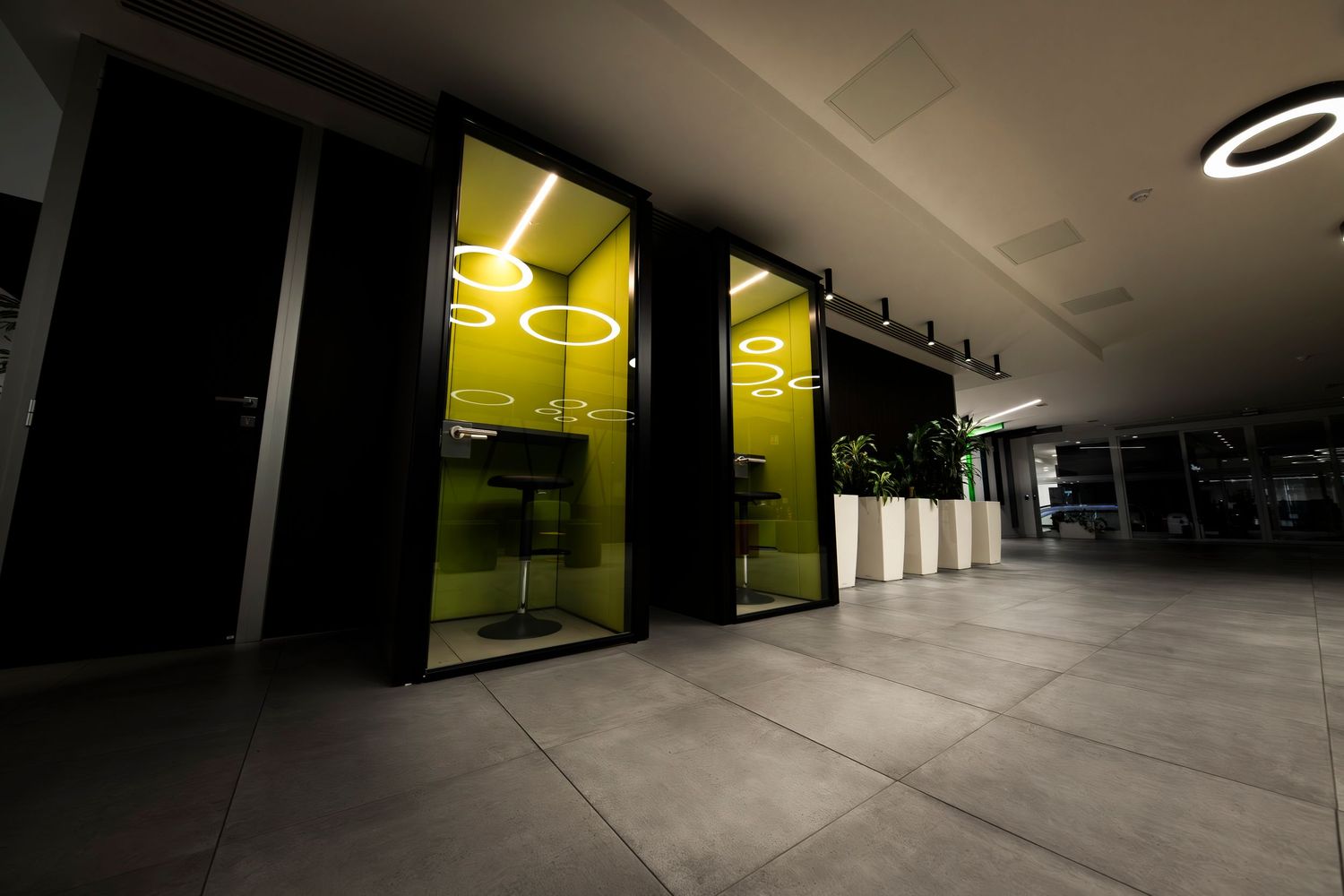 Industrial-style hallway with dramatic lighting and concrete floors creating a modern atmosphere.