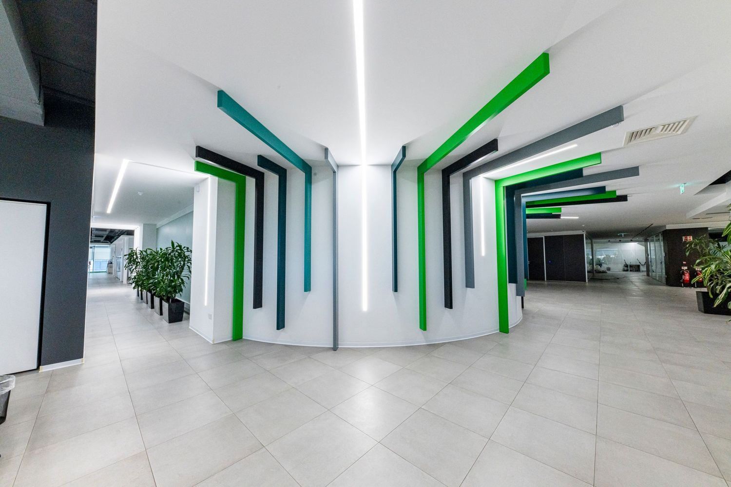 Modern office interior with geometric green and white design elements on walls.