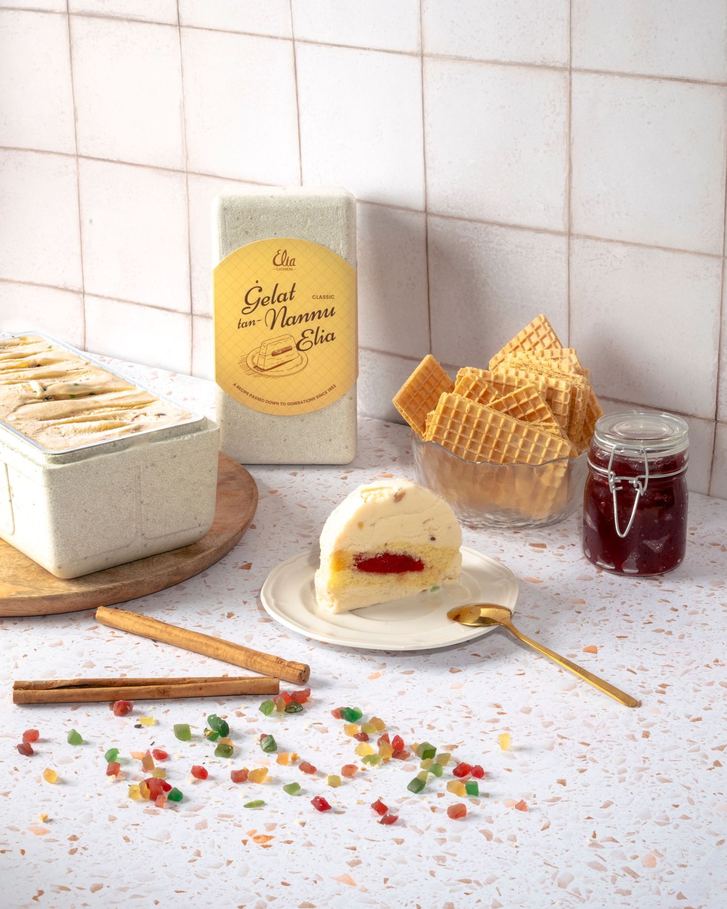 Dessert spread with cake slices, jam, and pastries on a white tiled counter.