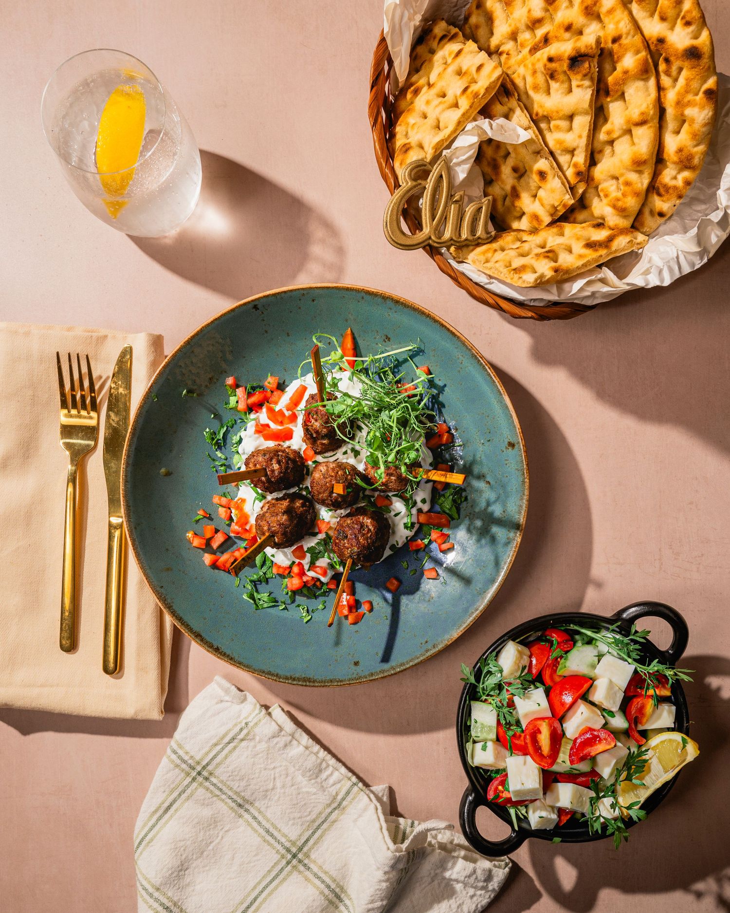 Gourmet meal presentation featuring blue ceramic plates with colorful salads and appetizers.