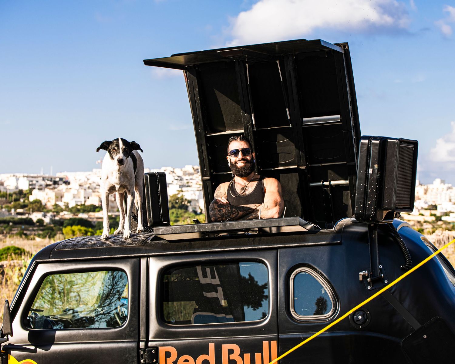 Red Bull branded support vehicle parked along a race course.