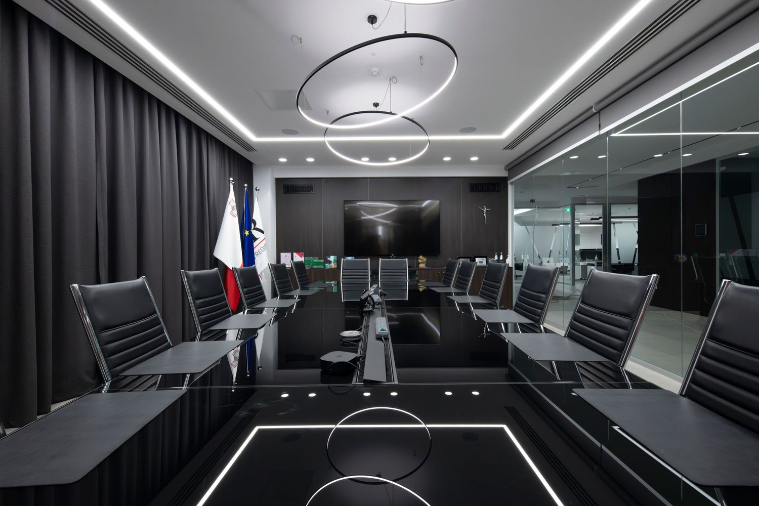 Modern meeting room featuring distinctive circular ceiling lights and glass walls.
