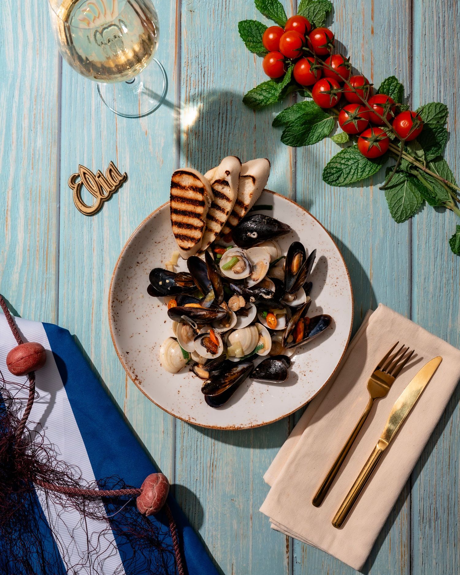 Grilled mushrooms and seafood served with fresh berries on rustic blue wooden table.