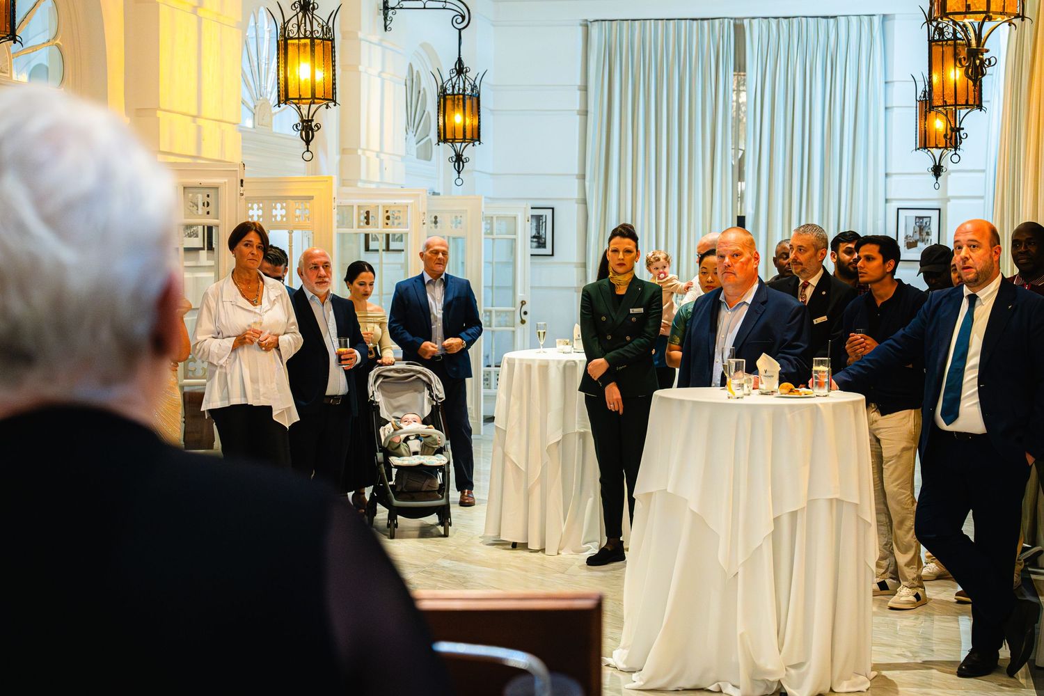 Professional event at The Phoenicia featuring a white-clothed table and hanging lanterns in an elegant setting.