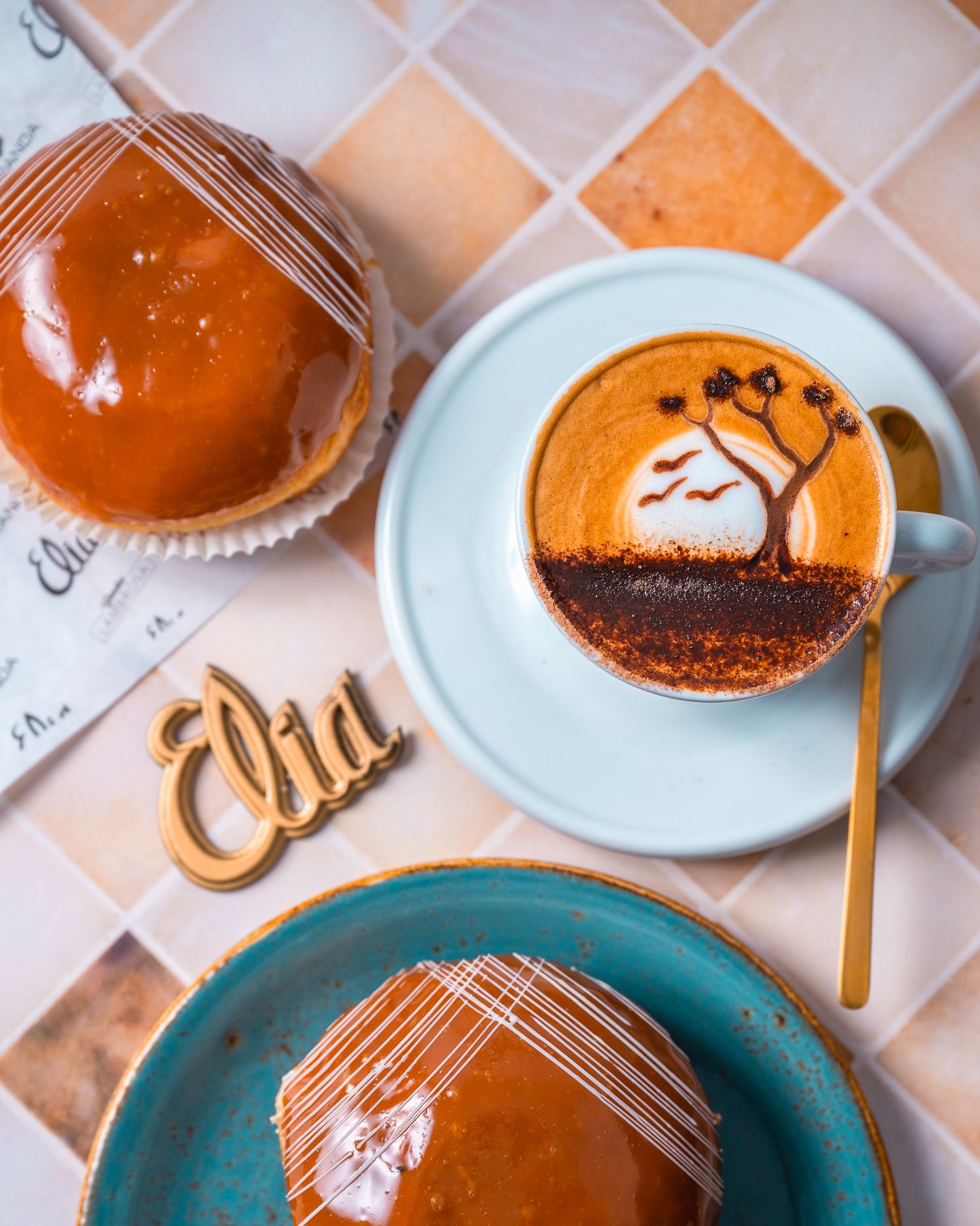 Orange-colored desserts with decorative patterns served on turquoise and white plates.