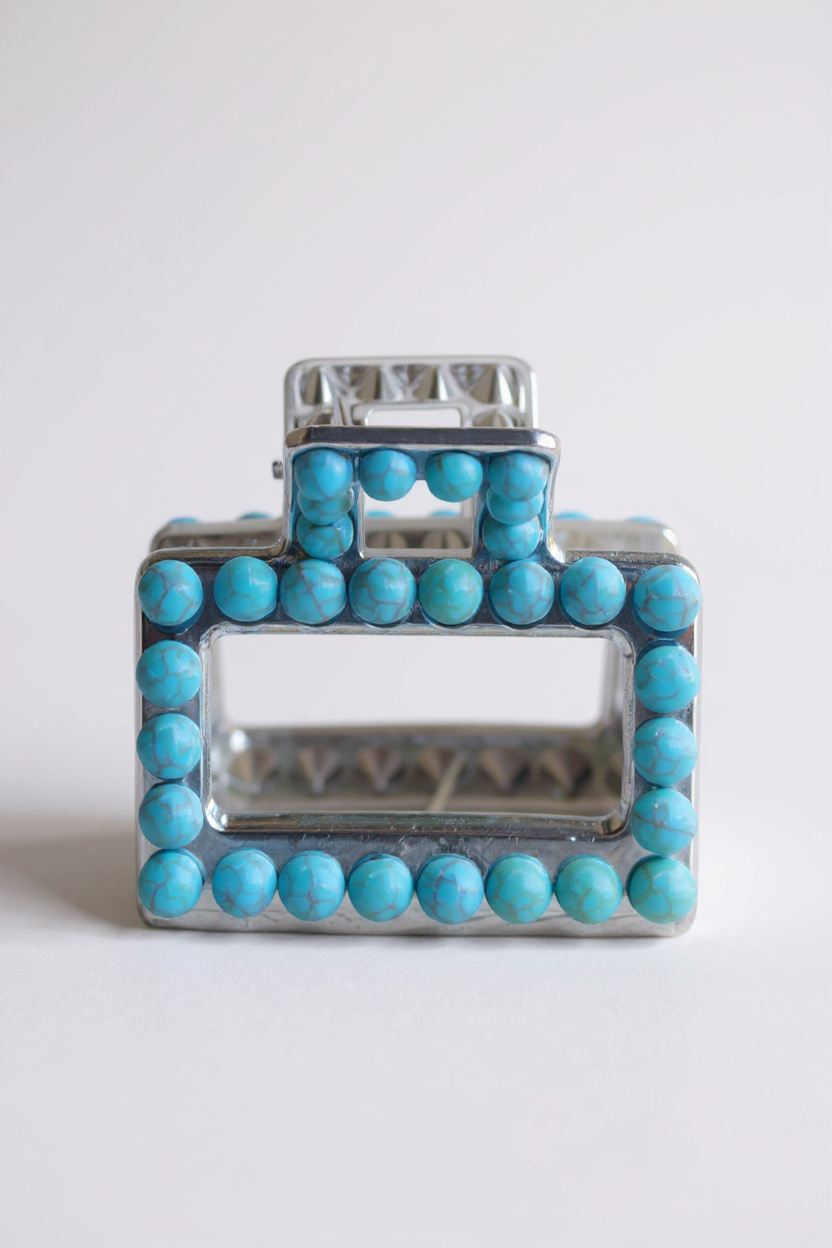 Silver hair barrette decorated with turquoise beads shown from different angles.