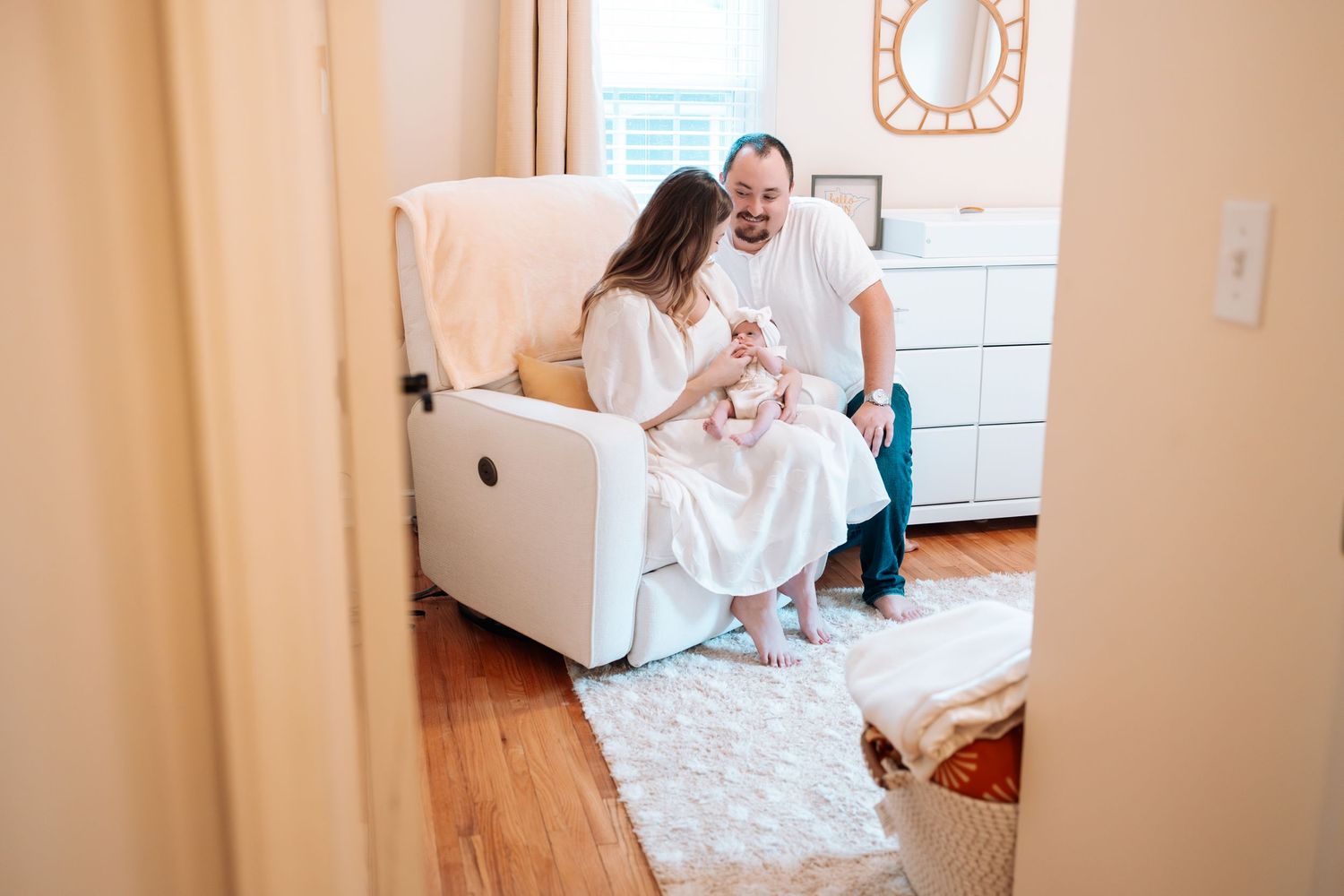 Lifestyle photography session in bright indoor nursery setting.