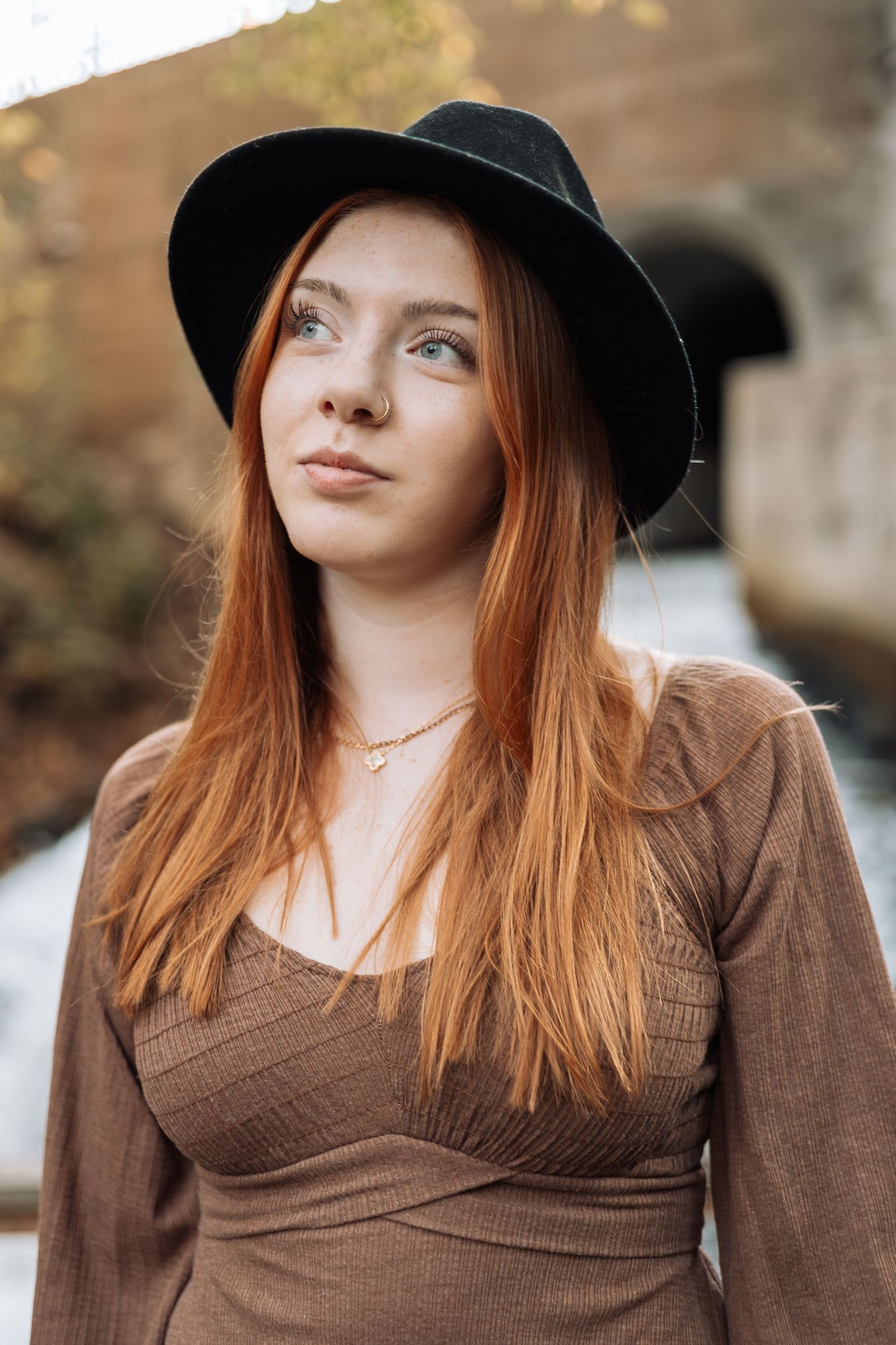 Portrait in brown sweater and black hat with natural autumn background with Kenzie Ayla Images in the Twin Cities MN area.