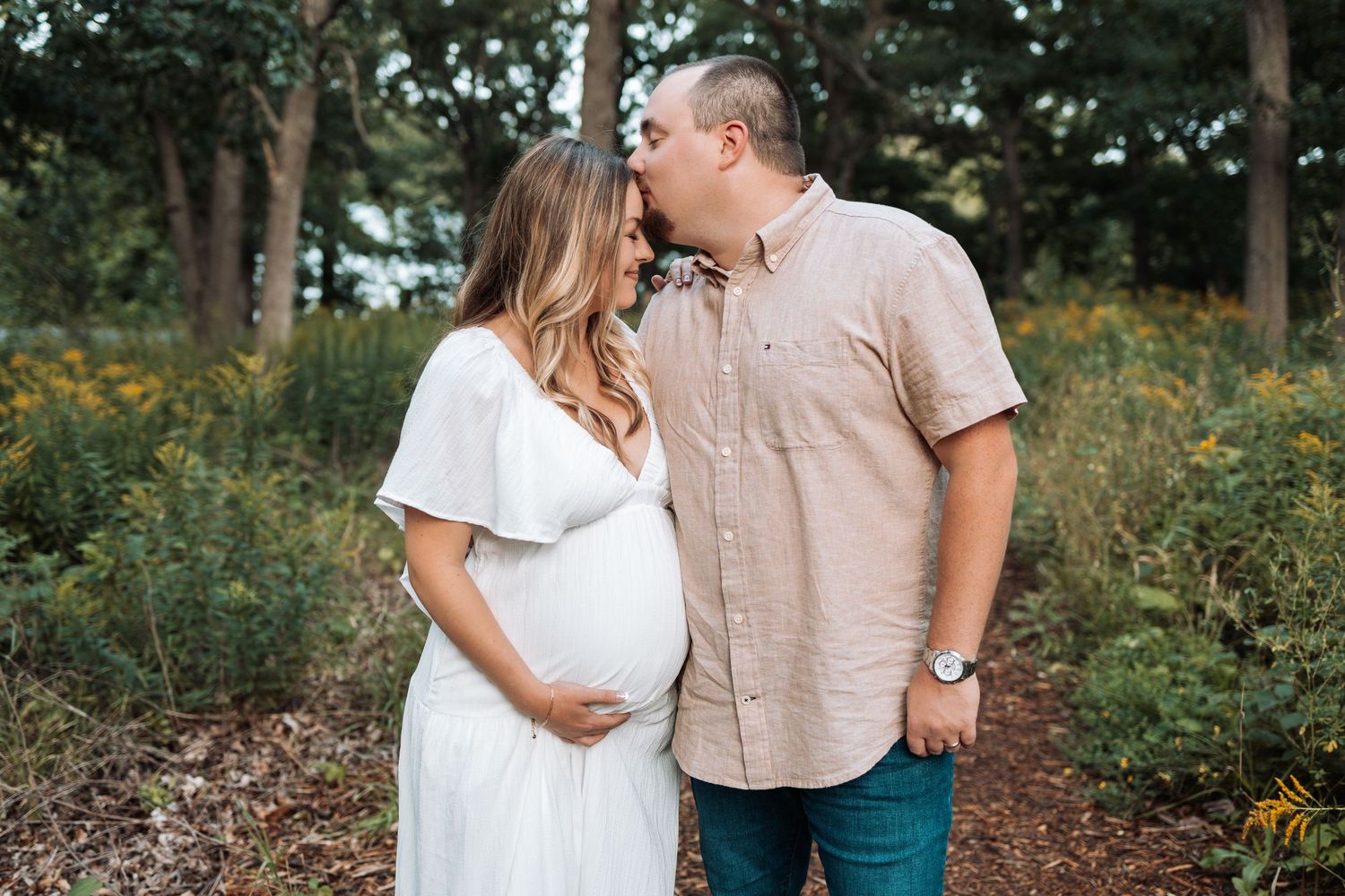 Romantic outdoor couples photography session with natural woodland backdrop.