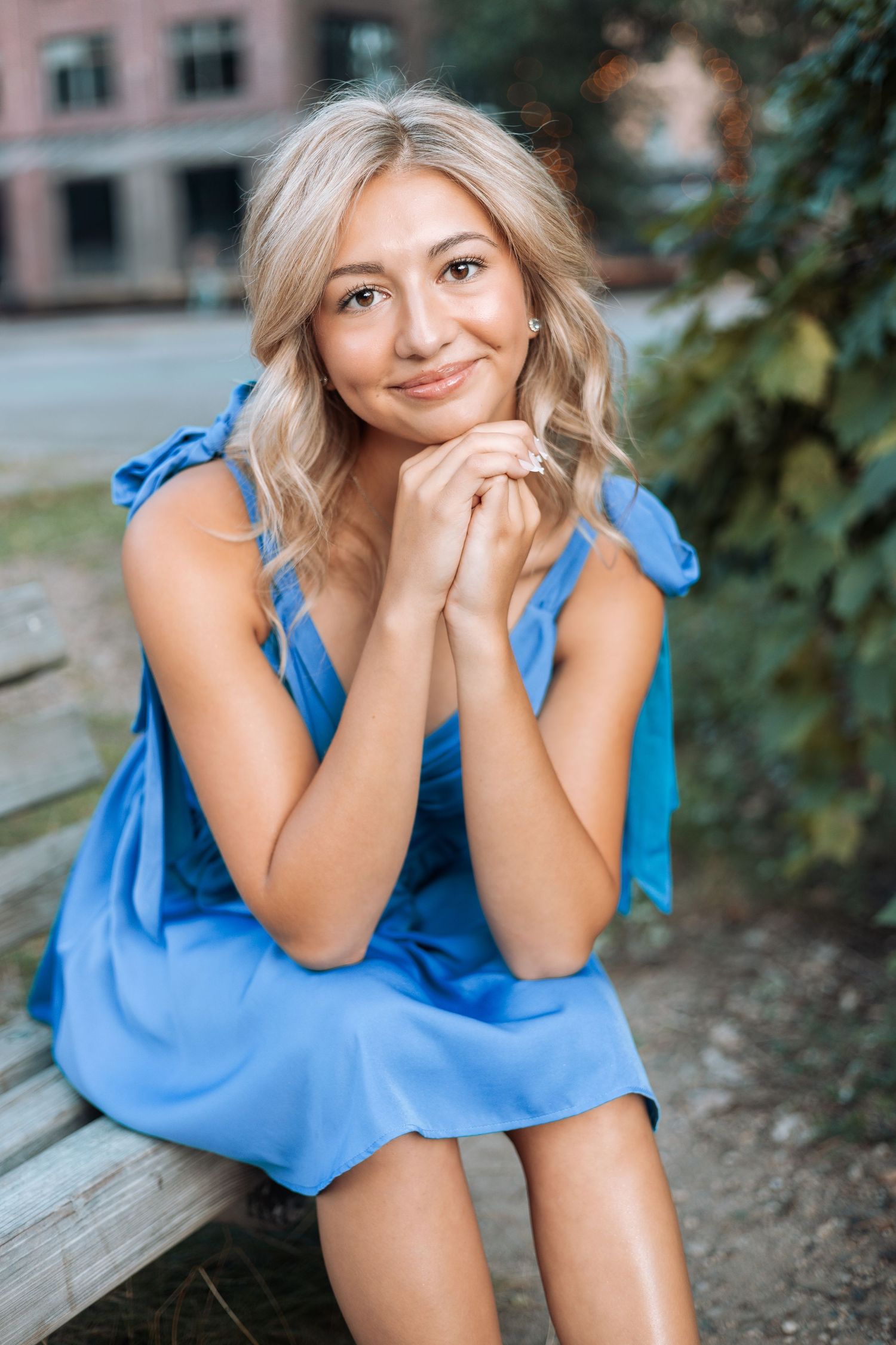 Portrait in blue summer dress sitting on wooden bench with Kenzie Ayla Images in the Twin Cities MN area.