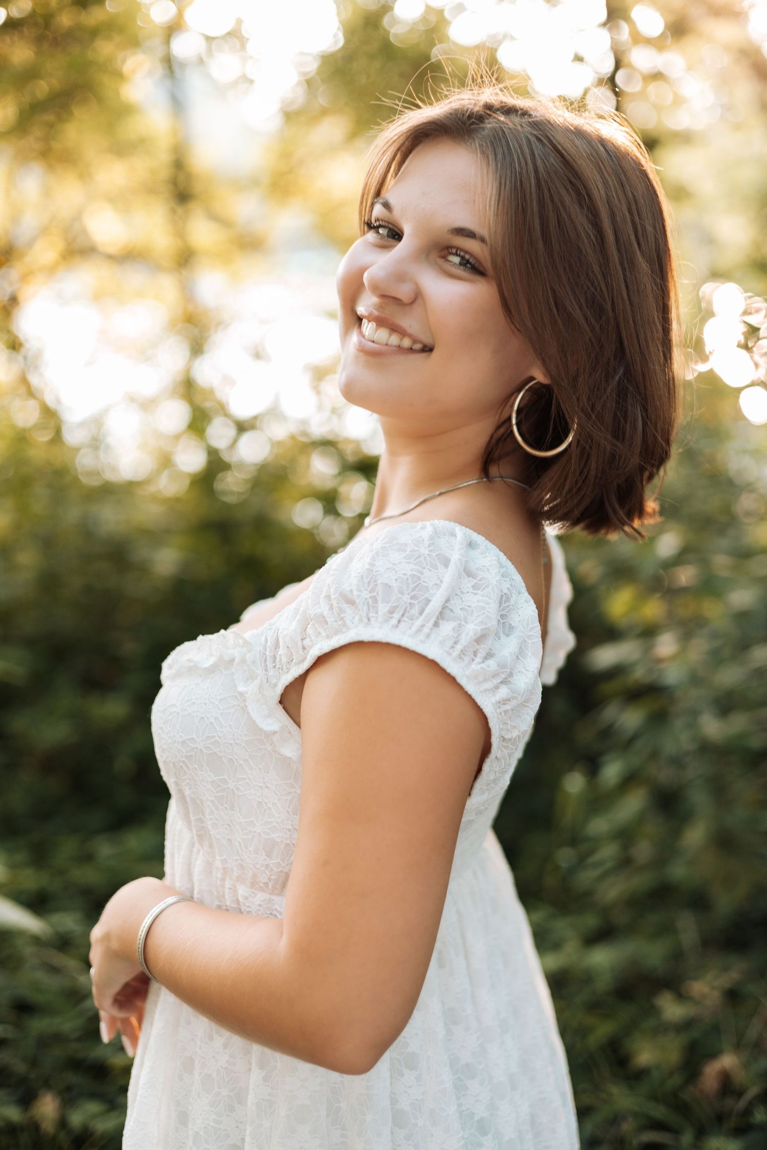 Portrait in white summer dress against sunset bokeh background with Kenzie Ayla Images in the Twin Cities MN area.
