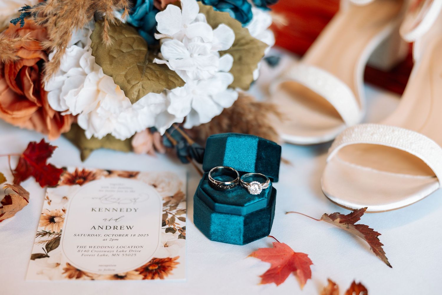 Wedding details with teal decor boxes, white flowers and autumn leaves on table with Kenzie Ayla Images in the Twin Cities MN area.