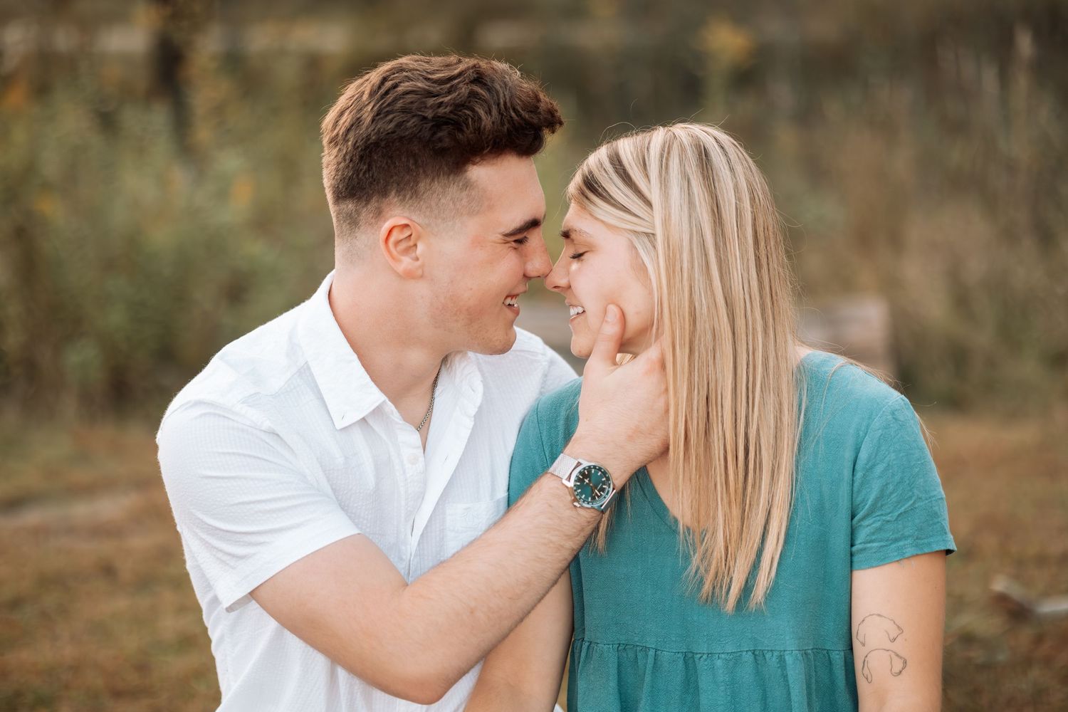 Couple sharing intimate moment in outdoor summer setting.