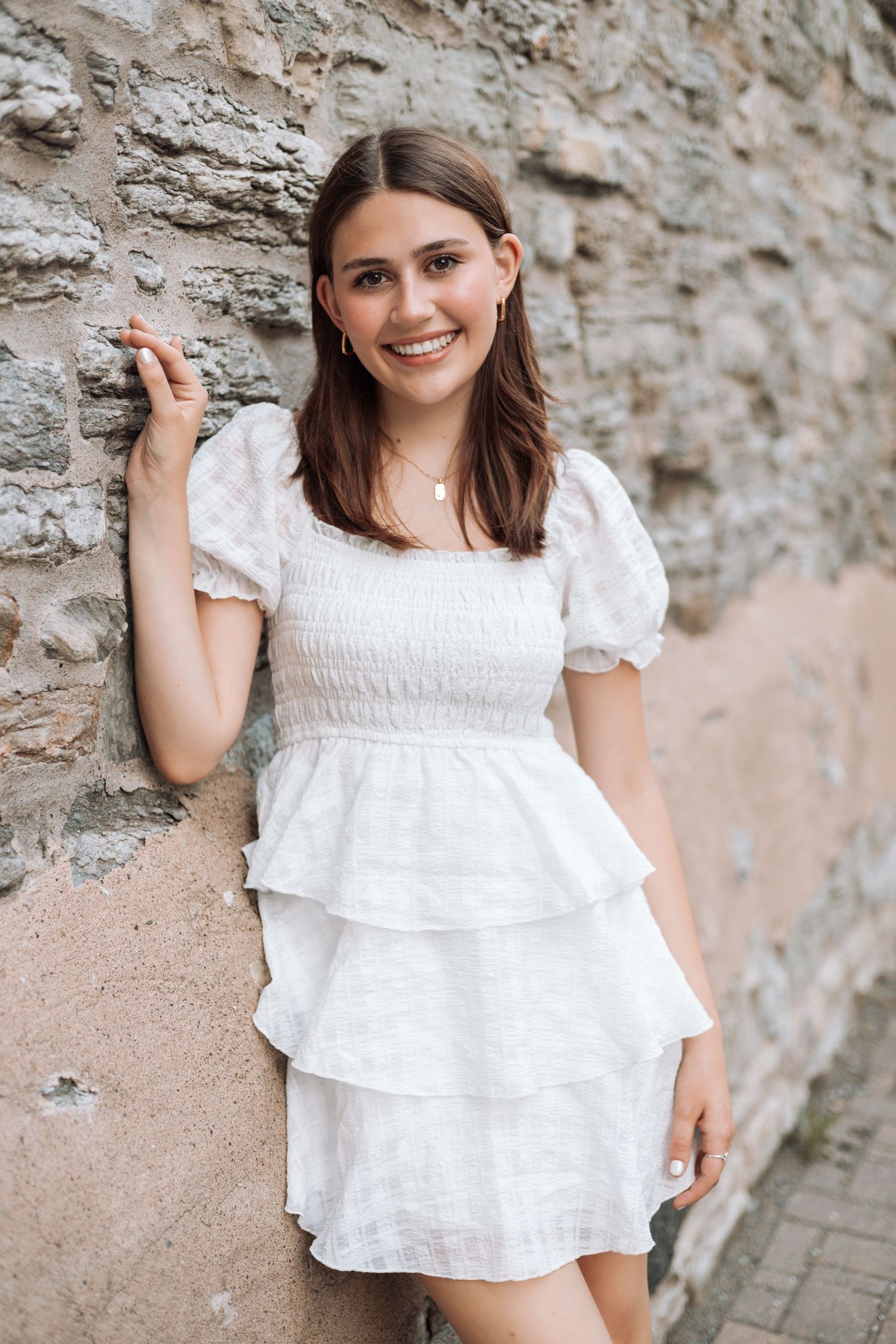 White ruffled summer top styled against stone wall backdrop with Kenzie Ayla Images in the Twin Cities MN area.