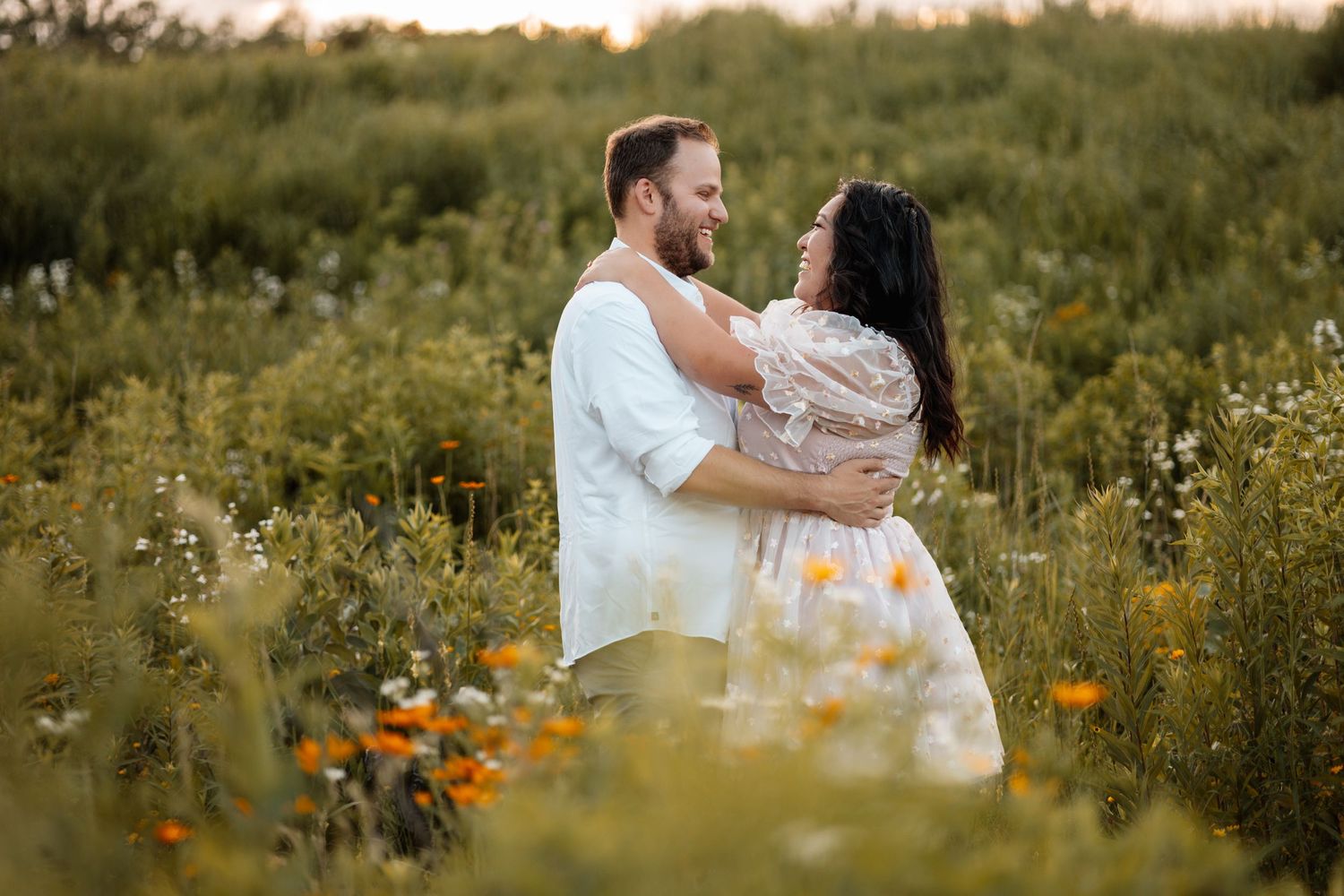 Romantic photoshoot in a wildflower meadow during sunset.