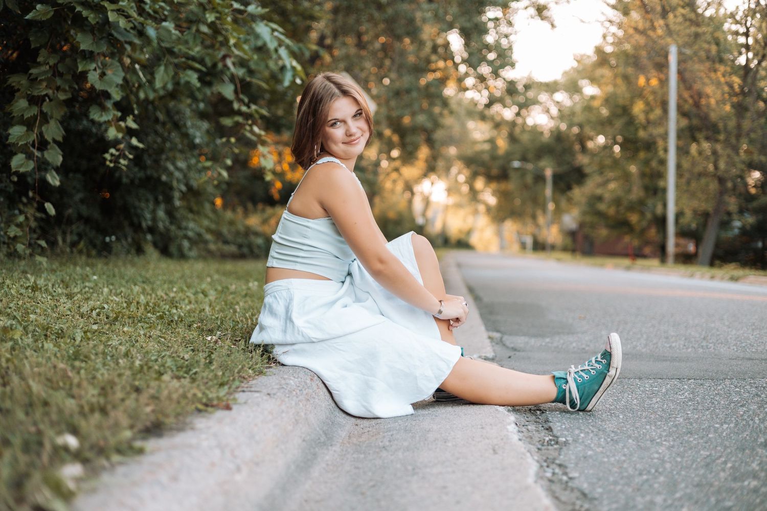 Casual summer portrait sitting on sidewalk in light dress with Kenzie Ayla Images in the Twin Cities MN area.