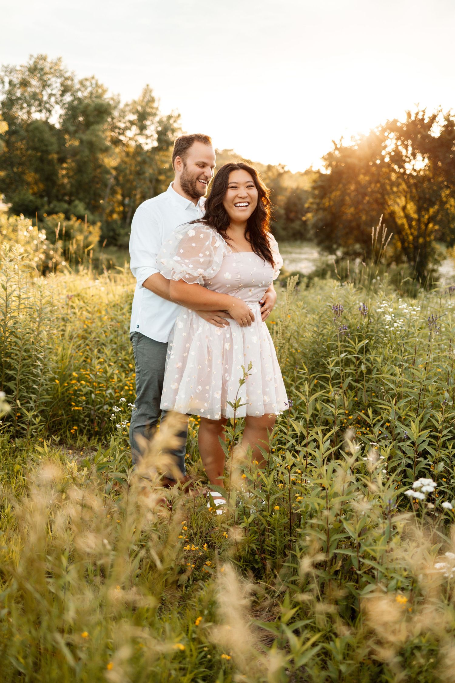 Romantic sunset photoshoot in a wildflower meadow with golden light.