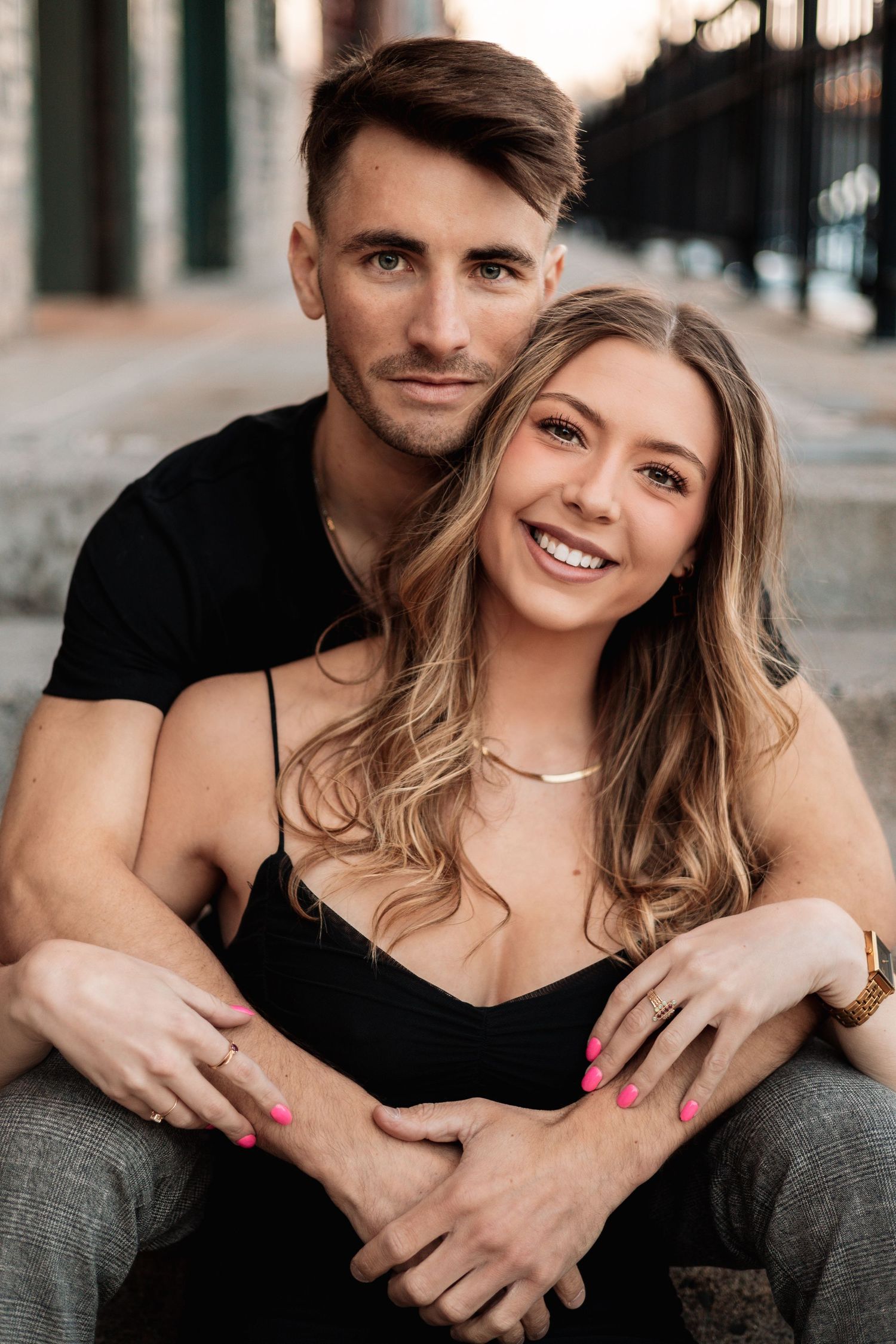Intimate couple portrait session with black and grey tones in urban setting.
