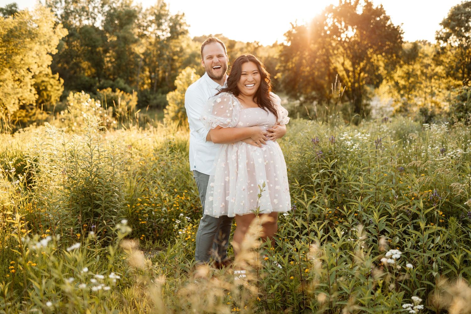 Romantic sunset photoshoot in a field of wild summer flowers.