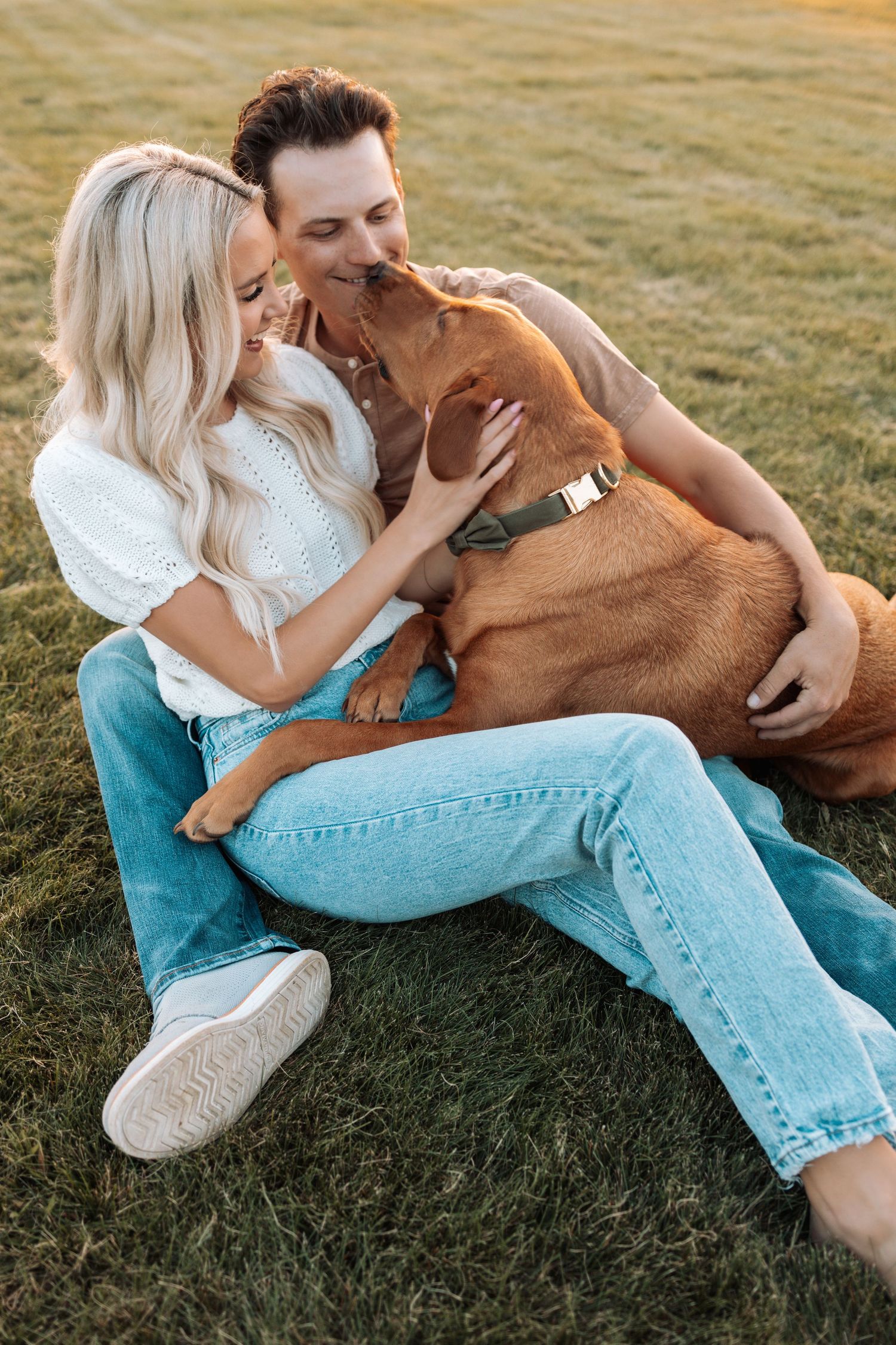 A couple relaxing on grass sharing affectionate moments together.