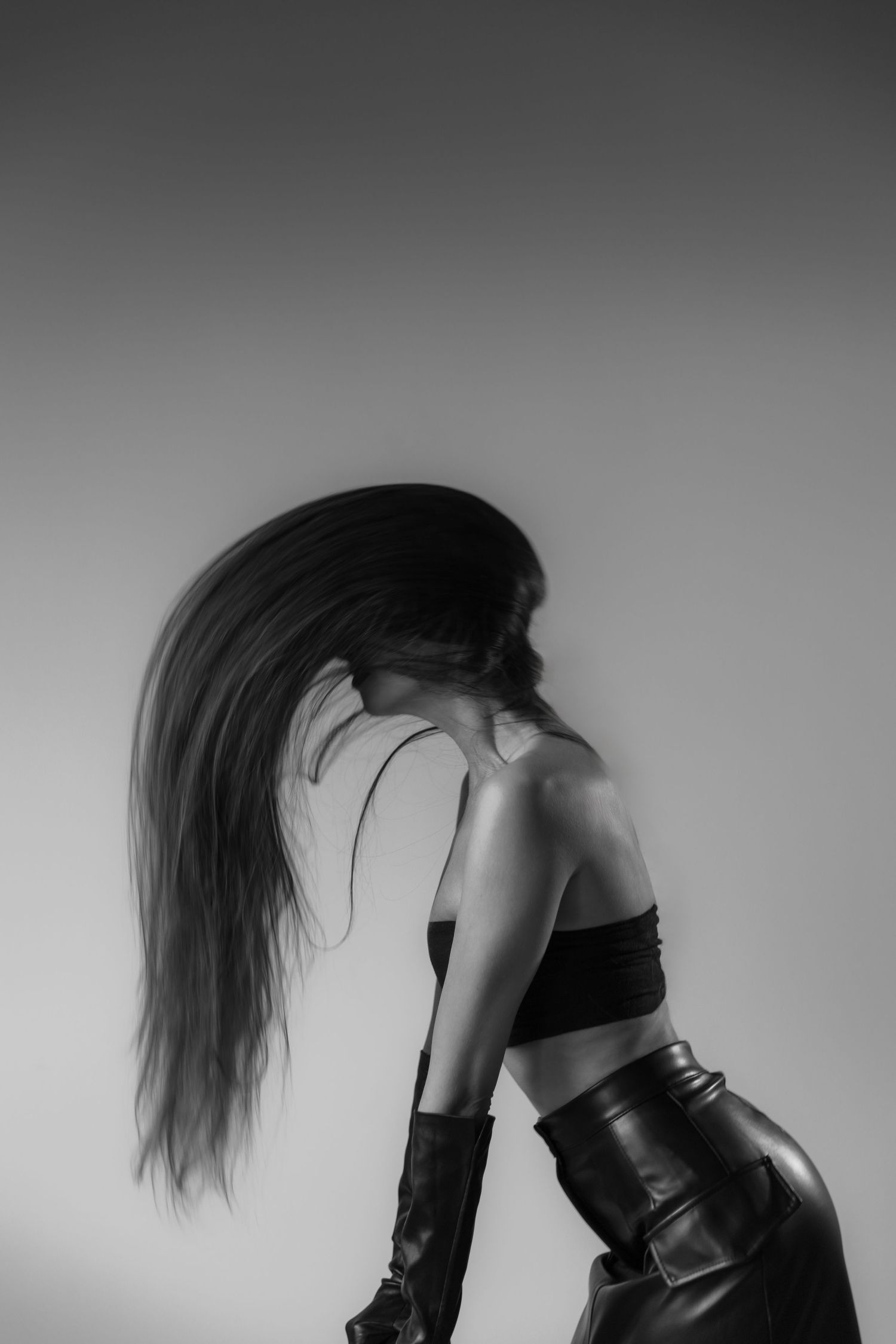 Dramatic black and white fashion portraits with flowing hair movement.