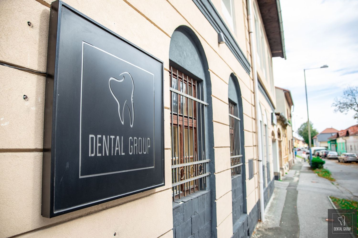 Exterior view of a modern dental office with minimalist signage on building facade.