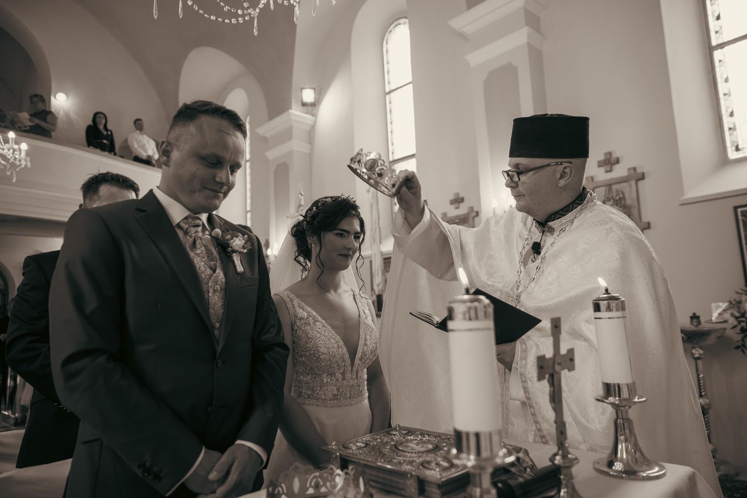 Black and white photograph of a wedding ceremony in a traditional church setting.