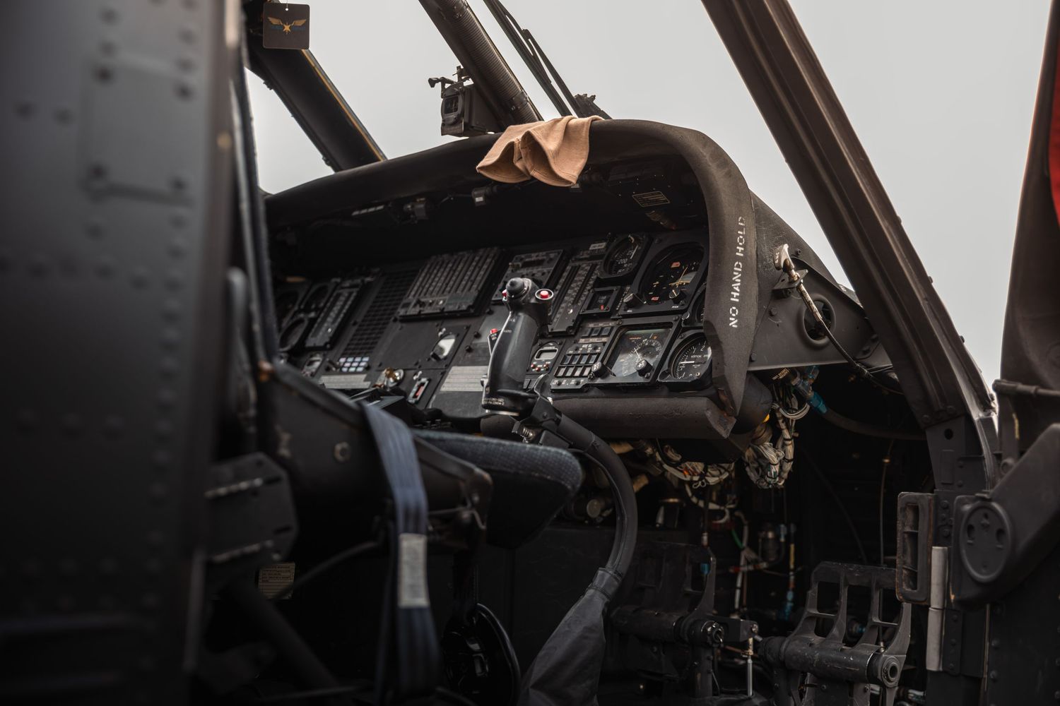 Interior view of helicopter cockpit showing instrument panels and controls.