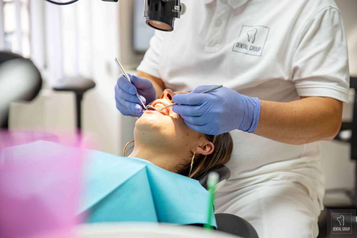 Dental procedure being performed with modern tools and protective equipment in clinical setting.
