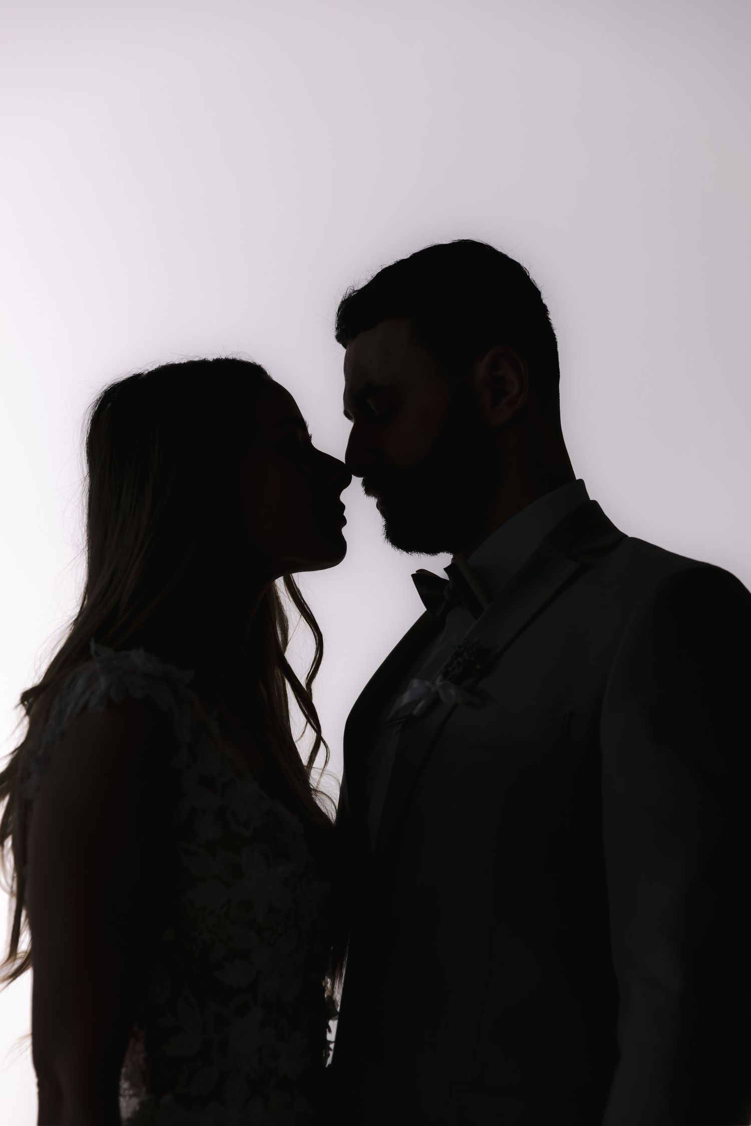 Silhouette series of romantic couple moments against white background.