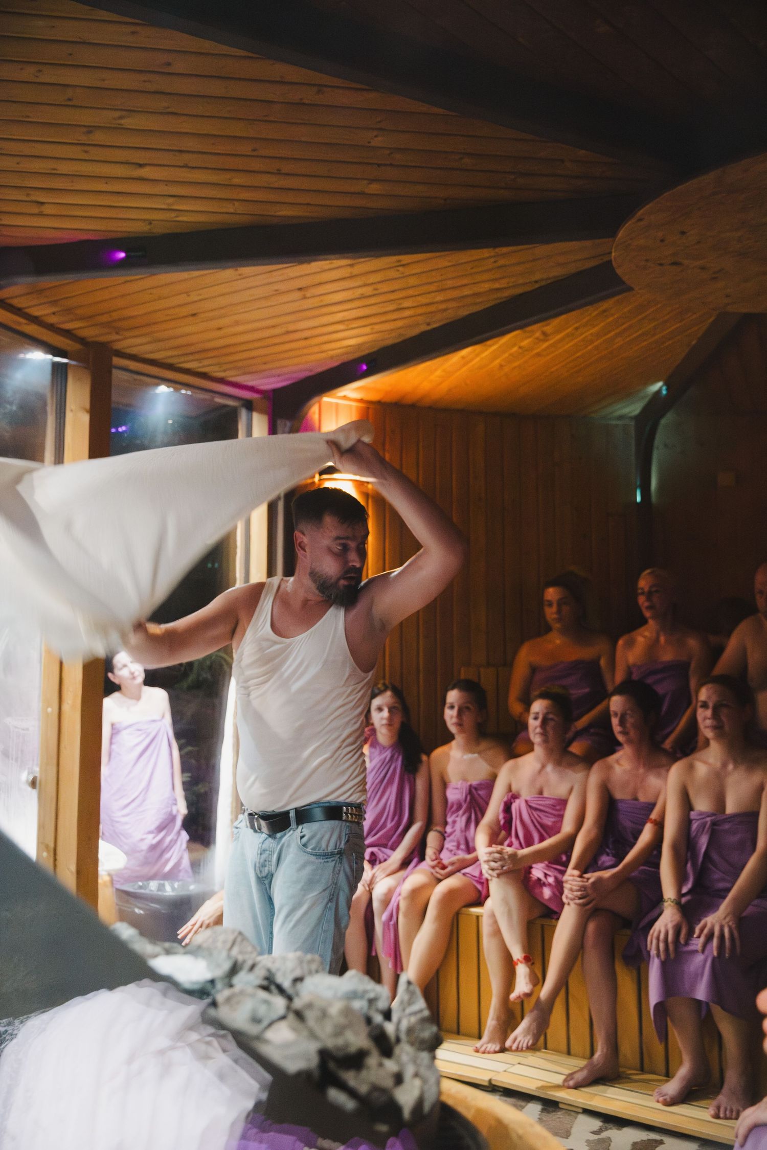 Performance preparation scene with purple-clad performers in a wood-paneled room.
