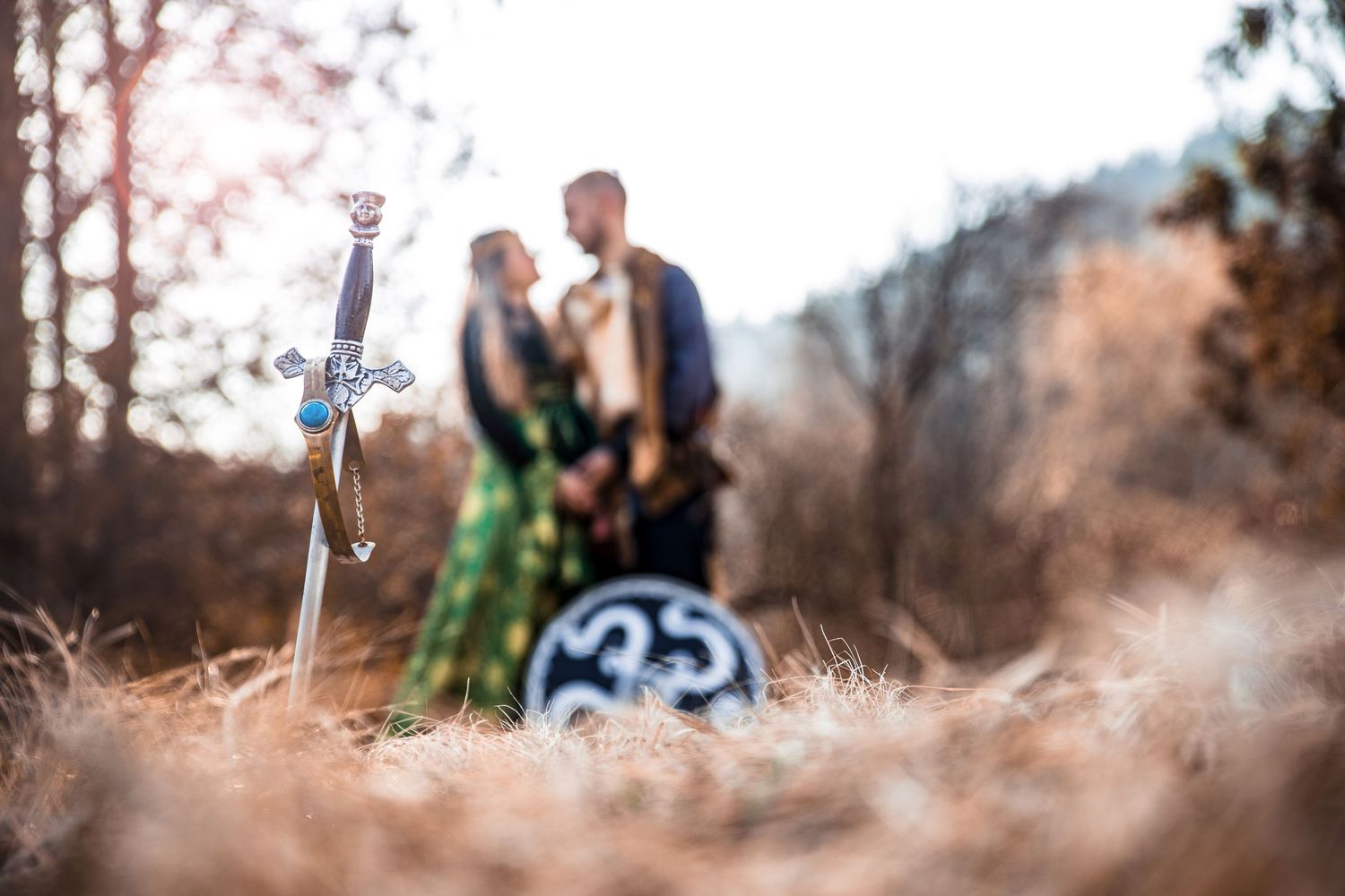 A blurred outdoor portrait with bokeh effect and natural scenery in the background.