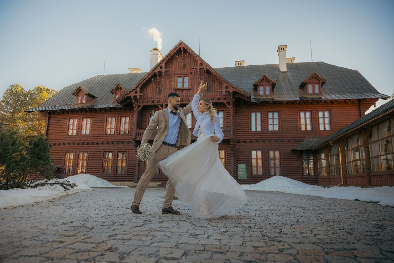 Rustic brick building exterior with cobblestone pathway during golden hour.
