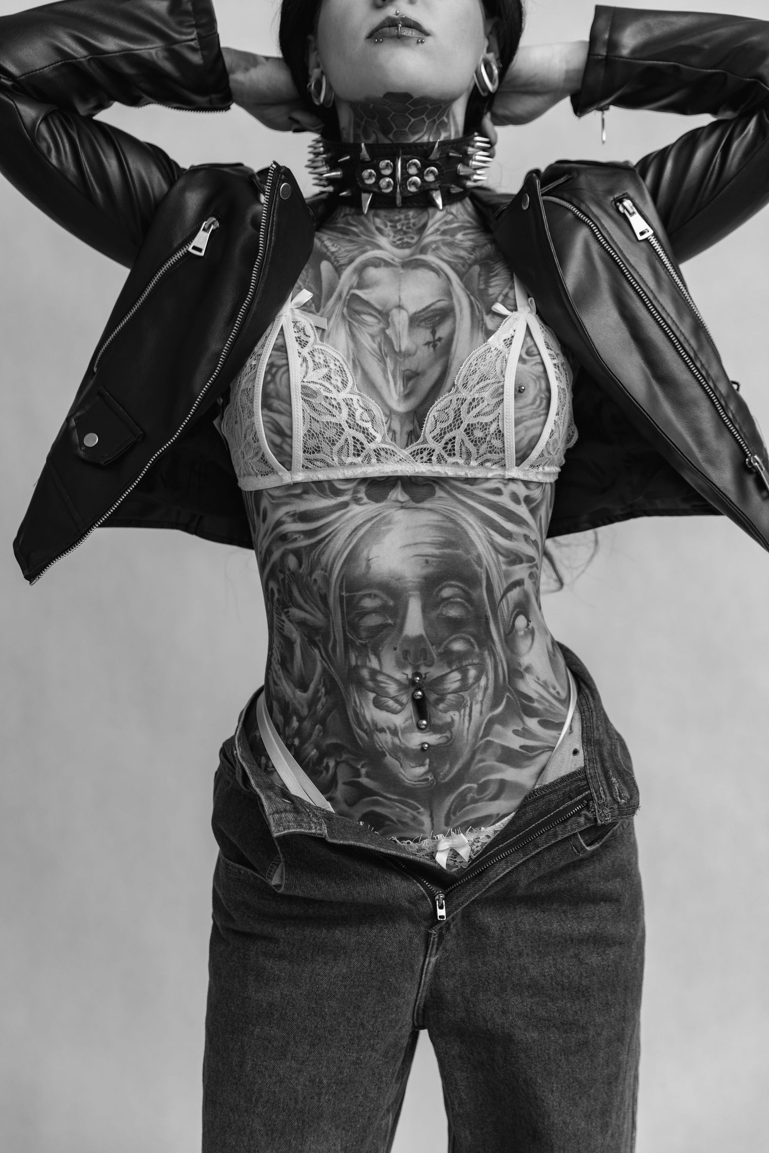 Black and white photography showcasing an intricate torso tattoo design.