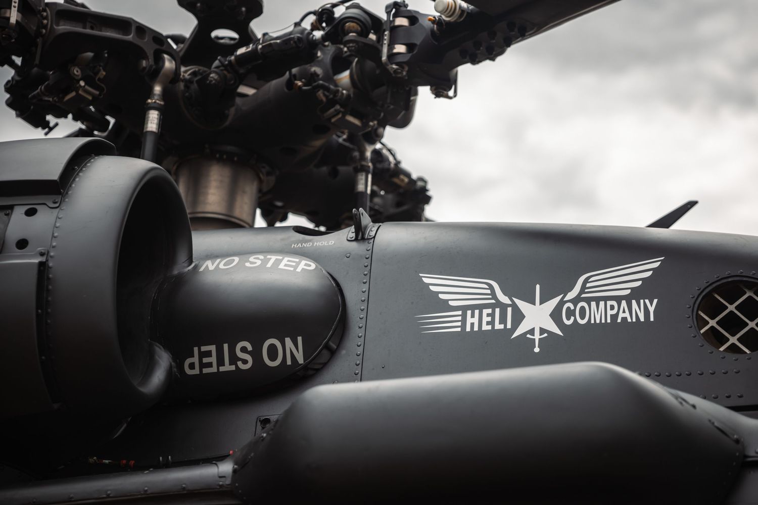 Close-up detail of military helicopter exterior showing company branding and markings.