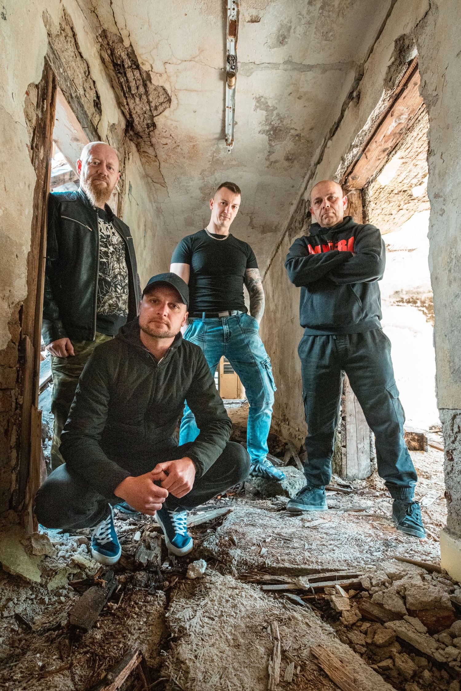 Group explores the rubble-strewn floor of a derelict building.