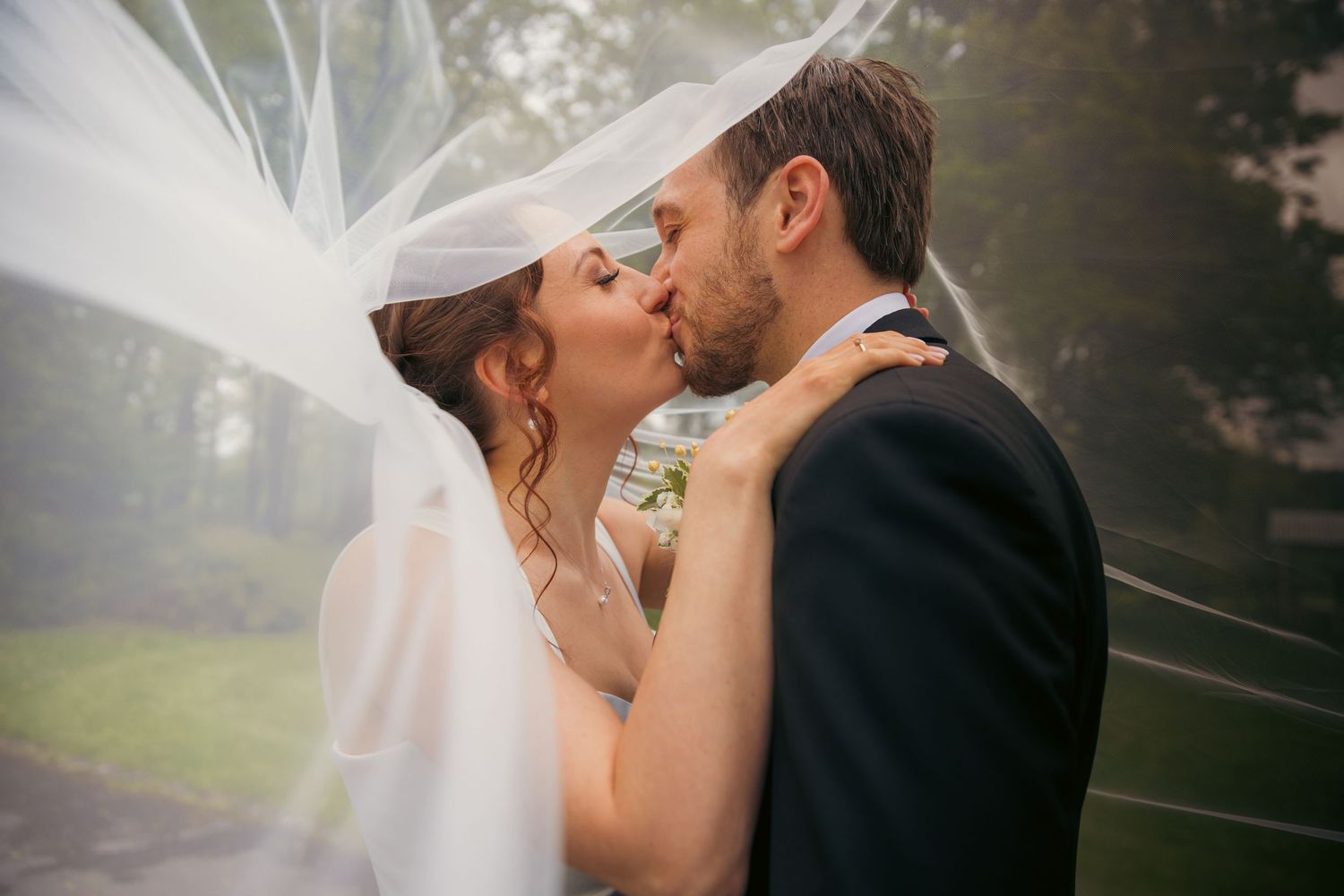 Romantic wedding moment captured in soft misty lighting.