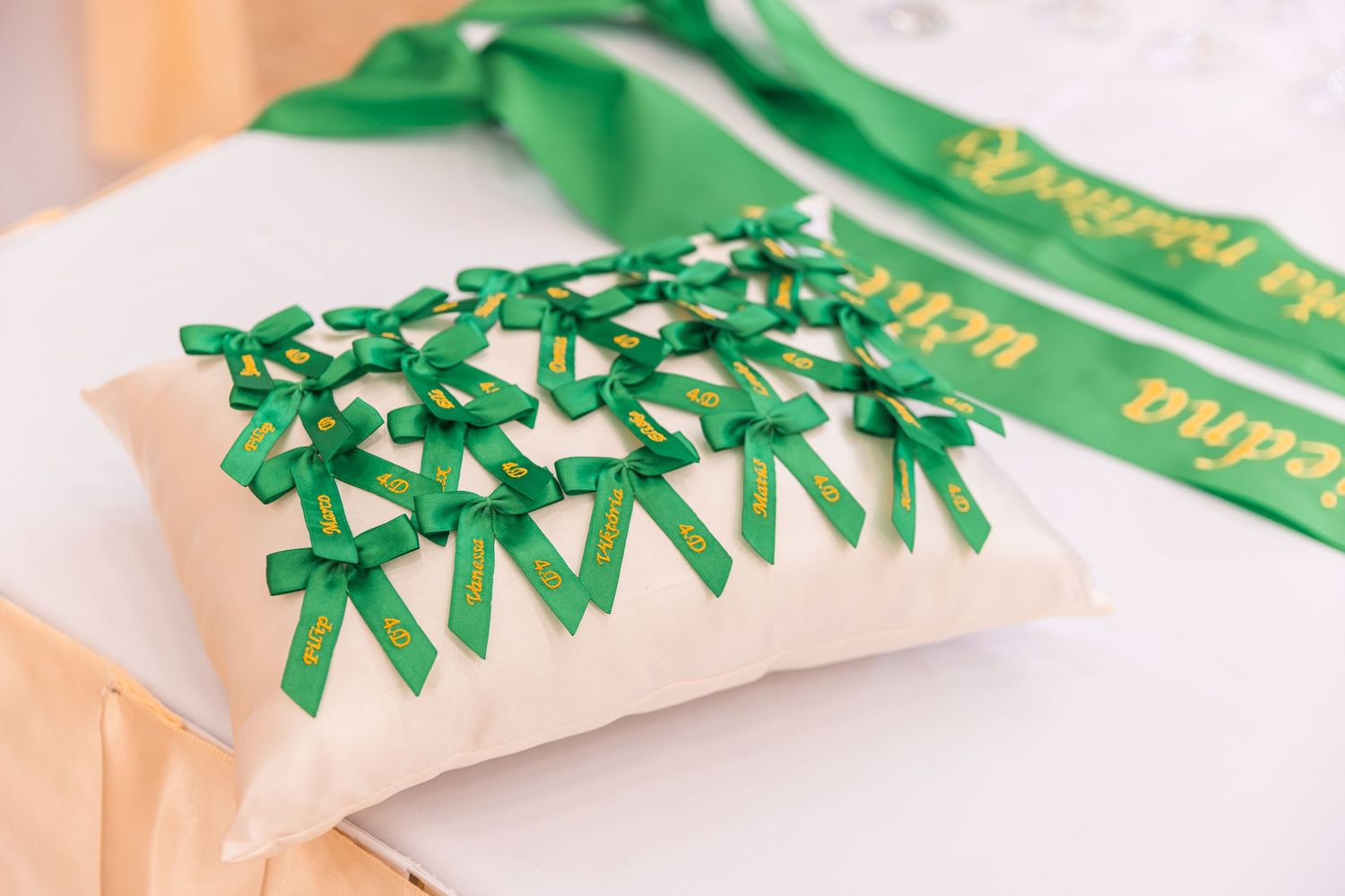 Green ribbon bows and decorative elements arranged on a light surface.