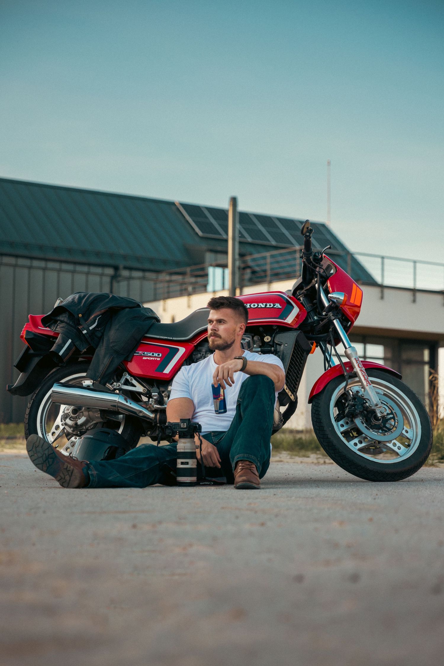 Red motorcycle laid on its side for a creative photoshoot sequence.